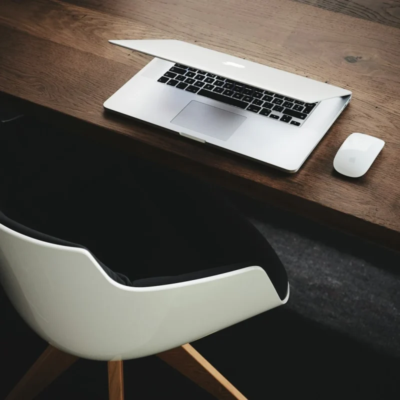 Apple-MacBook-beside-computer-mouse-on-table