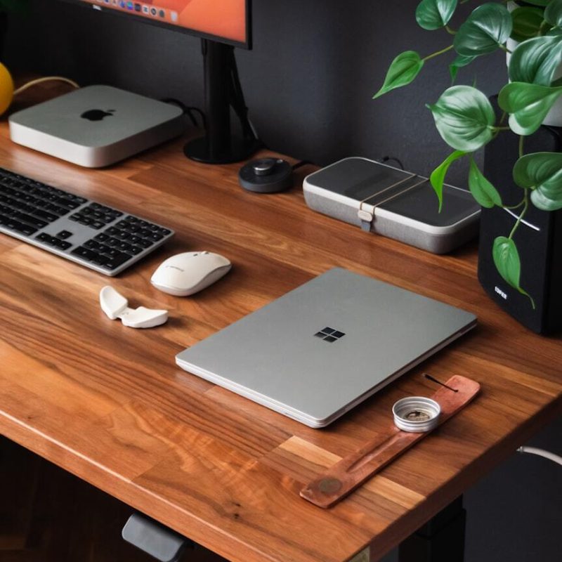 a-wooden-desk-topped-with-a-computer-monitor-and-keyboard