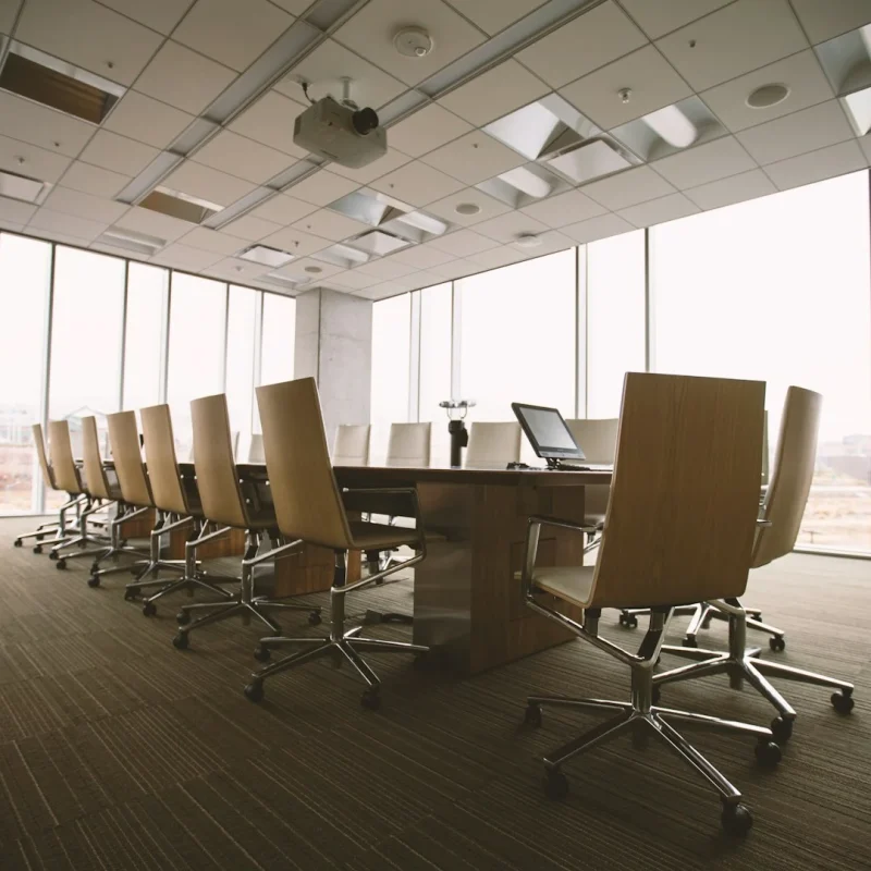 oval-brown-wooden-conference-table-and-chairs-inside-conference-room
